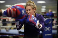 FILE - USA Boxing team member Ginny Fuchs takes part in drills during media day for the team in a gym located in a converted Macy's Department store in Colorado Springs, Colo., in this Monday, June 7, 2021, file photo. Fuchs’ obsessive-compulsive disorder sometimes compels her to use a dozen toothbrushes a night and to buy hundreds of dollars of cleaning products per week. Yet Fuchs is headed to Tokyo next week to compete in the Olympic boxing tournament, where she realizes it’s almost impossible to avoid touching the blood, sweat and spit of her opponents.(AP Photo/David Zalubowski, File)