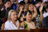 YANGON, MYANMAR - NOVEMBER 19: US Secretary of State Hilary Clinton (L) listens alongside Aung San Suu Kyi as US President Barack Obama speaks at the University of Yangon during his historical first visit to the country on November 19, 2012 in Yangon, Myanmar. Obama is the first US President to visit Myanmar while on a four-day tour of Southeast Asia that also includes Thailand and Cambodia. (Photo by Paula Bronstein/Getty Images)