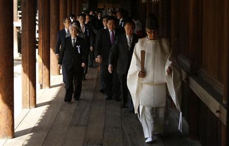 A group of lawmakers are led by a Shinto priest as they visit Yasukuni Shrine in Tokyo April 22, 2014. REUTERS/Yuya Shino