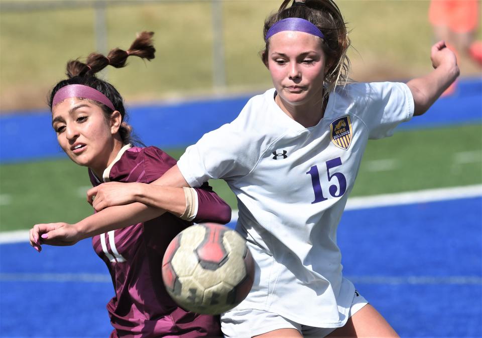 Wylie's Teagan Brown, right, battles El Paso Andress' Andrea Iniguez for the ball. Andress beat the Lady Bulldogs 5-4 in overtime in the Region I-5A area playoff game Monday, March 27, 2023, at Astound Broadband Stadium in Midland.
