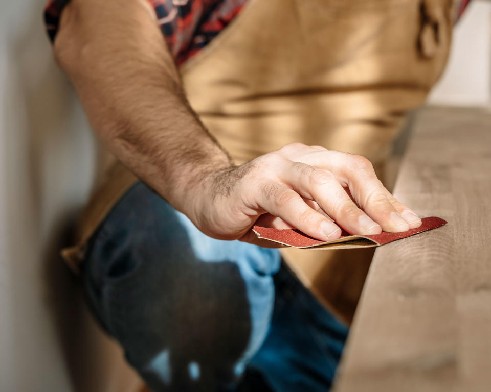 sanding edge of wood manually with sandpaper