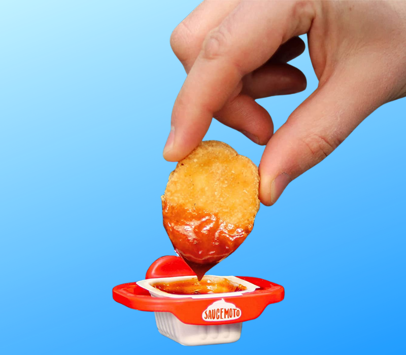 Someone dipping a chicken nugget in ketchup