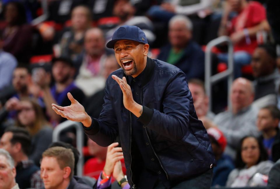 Jalen Rose cheers in the second half of an NBA basketball game between the Detroit Pistons and New Orleans Pelicans in Detroit, Monday, Feb. 12, 2018. (AP Photo/Paul Sancya)