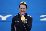 Flora Duffy of Bermuda holds her gold medal during a medal ceremony for the women's individual triathlon competition at the 2020 Summer Olympics, Tuesday, July 27, 2021, in Tokyo, Japan. (AP Photo/Charlie Riedel)