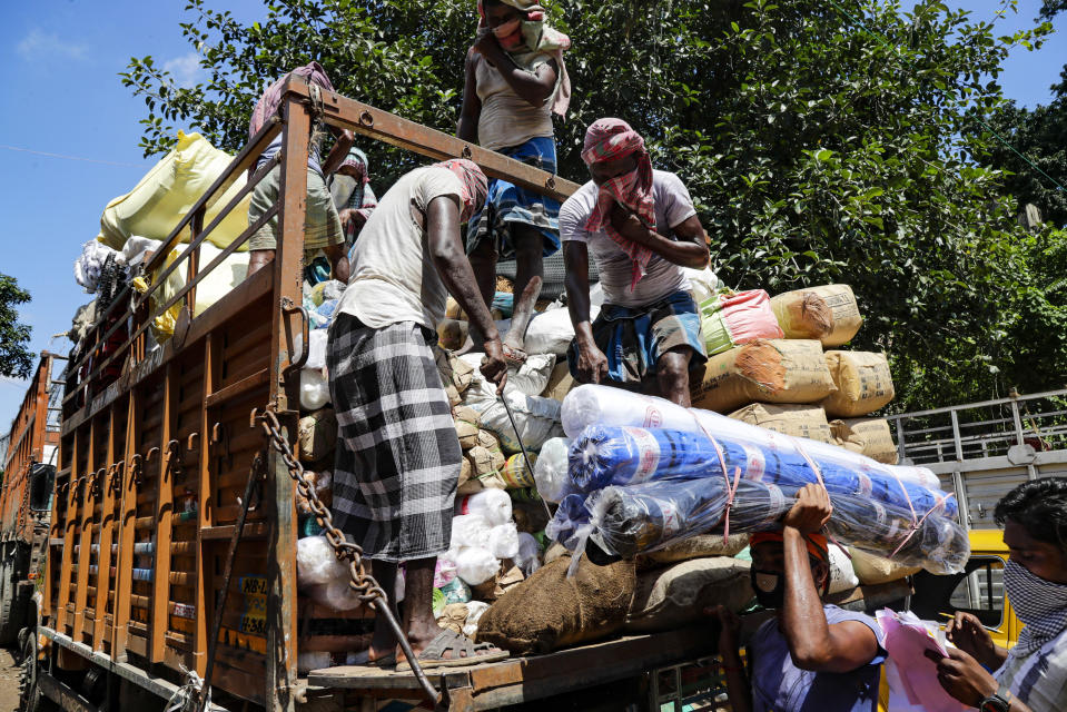 Laborers load a truck at a market area in Kolkata, India, Thursday, Sept. 3, 2020. India has registered a record single-day spike of 83,883 new coronavirus cases, driving the country overall tally to 3.85 million. The country has been reporting the highest single-day caseload in the world every day for more than three weeks and is the third worst-hit country behind the United States and Brazil. (AP Photo/Bikas Das)