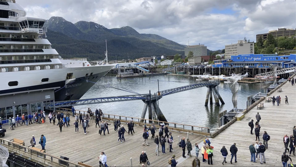 Passengers disembark from a cruise ship that has docked on June 12, 2023, in downtown Juneau, Alaska. As the Mendenhall Glacier continues to recede, tourists are flooding into Juneau. A record number of cruise ship passengers are expected this year in the city of about 30,000 people. (AP Photo/Becky Bohrer)