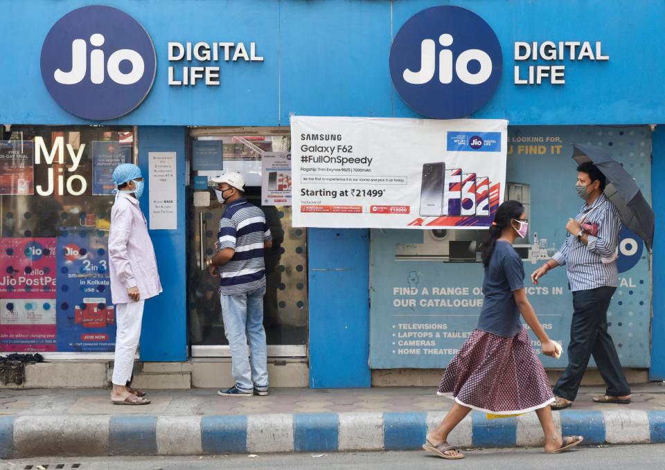 A girl walks past a Reliance Jio store in Kolkata, India, 03 March, 2021.