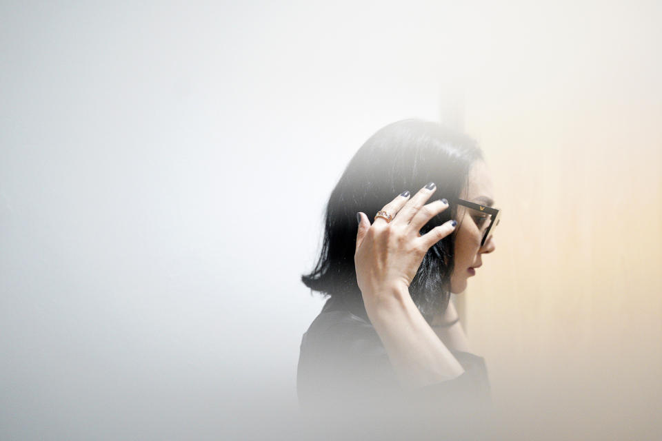 In this photo taken through frosted glass, Burmaa Oyubchineg, cousin of the murdered Mongolian model Altantuya Shaariibuu, arrives at Shah Alam High Court in Shah Alam, Malaysia, Wednesday, Jan. 23, 2019. A lawyer for the family of Altantuya said Wednesday, Jan. 23, 2019, they hope to find answers with a lawsuit that opened this week. (AP Photo/Yam G-Jun)