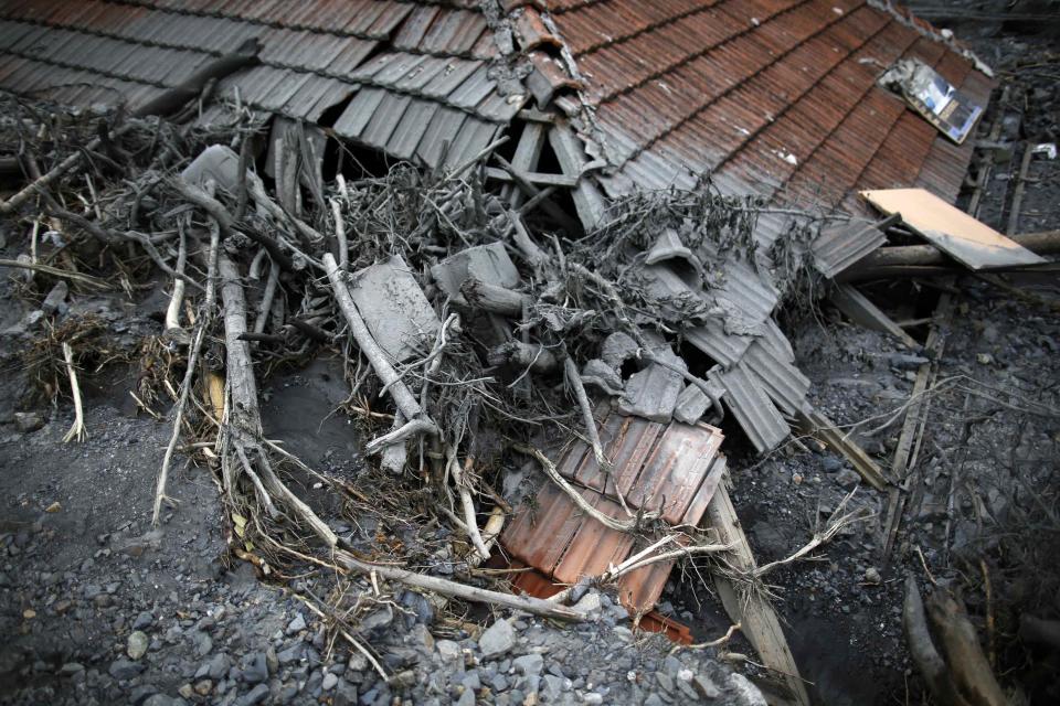 The roof of a flood-damaged house is seen in Topcic Polje