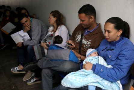 Venezuelan migrants queue to get the needed paperwork for a temporary residency permit at Interpol headquarters in Lima, Peru August 21, 2018.  REUTERS/Mariana Bazo