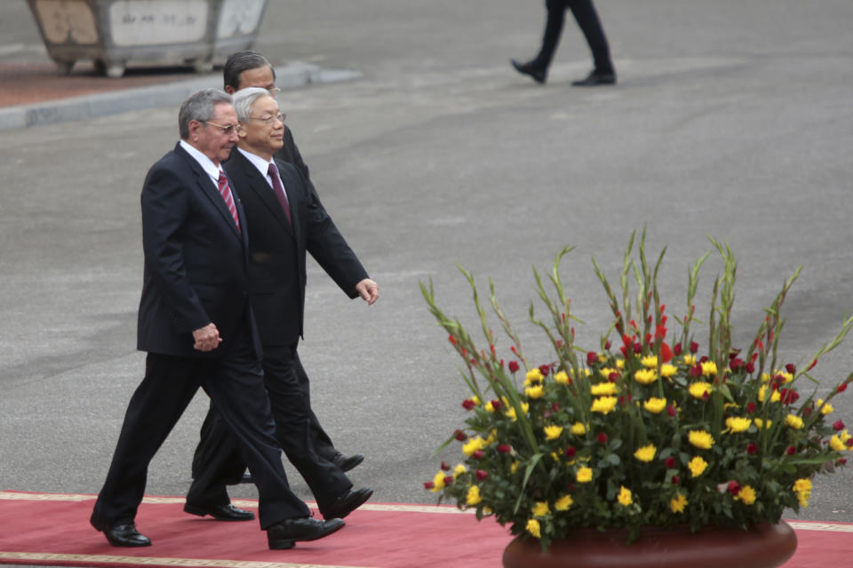 Cuban President Raul Castro, left, and Vietnamese General Secretary of Communist Party Nguyen Phu Trong, right, arrive at the welcome ceremony in Hanoi, Vietnam. Sunday, July 8, 2012. (AP Photo/Na Son Nguyen)