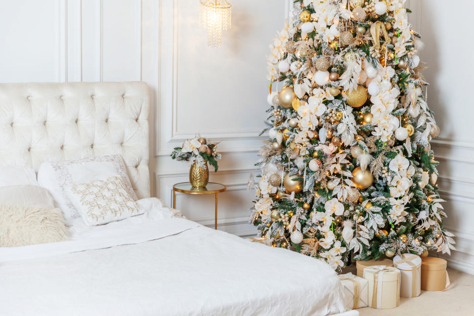 A Christmas tree in a bedroom, with white decorations. (Getty Images)