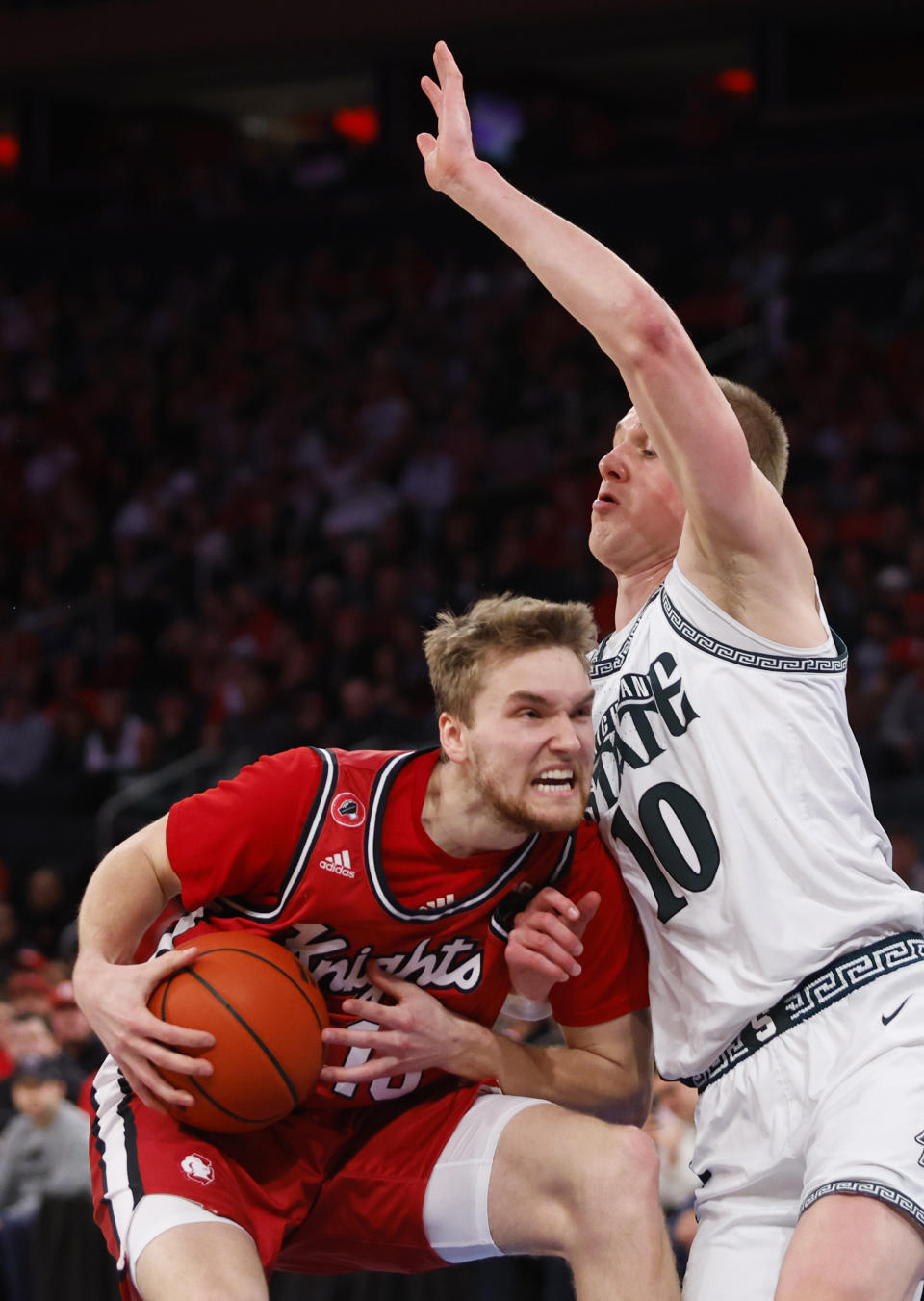 Rutgers guard Cam Spencer (10) drives to the basket against Michigan State forward Joey Hauser during the first half of an NCAA college basketball game in New York, Saturday, Feb. 4, 2023. (AP Photo/Noah K. Murray)