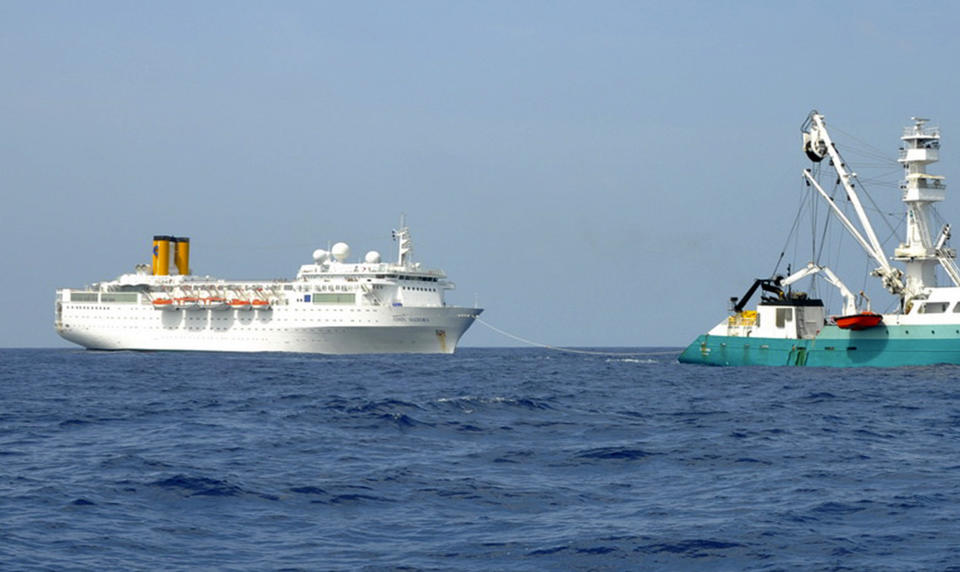 RETRANSMISSION TO PROVIDE ALTERNATIVE CROP - In this photo taken by a member of French fishing vessel, The Talenduic, and provided by the Prefecture of the Reunion Island, shows the Italian cruise ship, The Costa Allegra, left, being towed by French fishing vessel, The Trevignon, in the Indian Ocean, Tuesday, Feb. 28, 2012. The French fishing vessel The Trevignon on Tuesday began towing an Italian cruise ship drifting powerless in the Indian Ocean to a nearby Seychelles island, but was not expected to reach the tiny resort island until Wednesday, officials said. Seychelles authorities said they are making arrangements to evacuate people to the island of Desroches and then to transfer the more than 1,000 passengers and crew members to the main Seychelles island of Mahe by plane and fast boats. (AP Photo/Le Talenduic, Reunion Island Prefecture, HO)