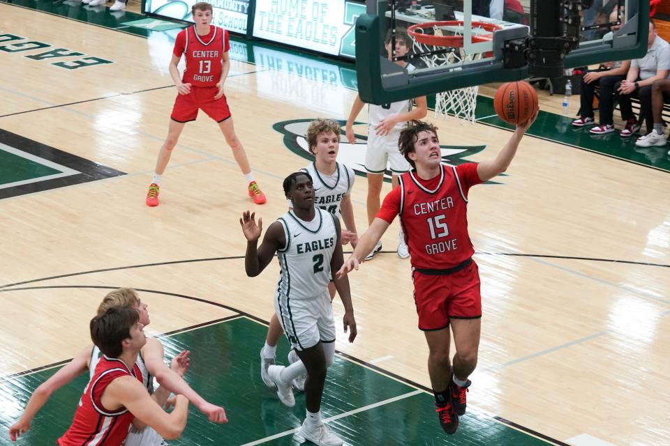 Center Grove Trojans Joey Schmitz (15) lays up the basketball Tuesday, Feb. 6, 2024, during the game at Zionsville High School in Zionsville, Indiana. The Center Grove Trojans defeated the Zionsville Eagles 60-49.