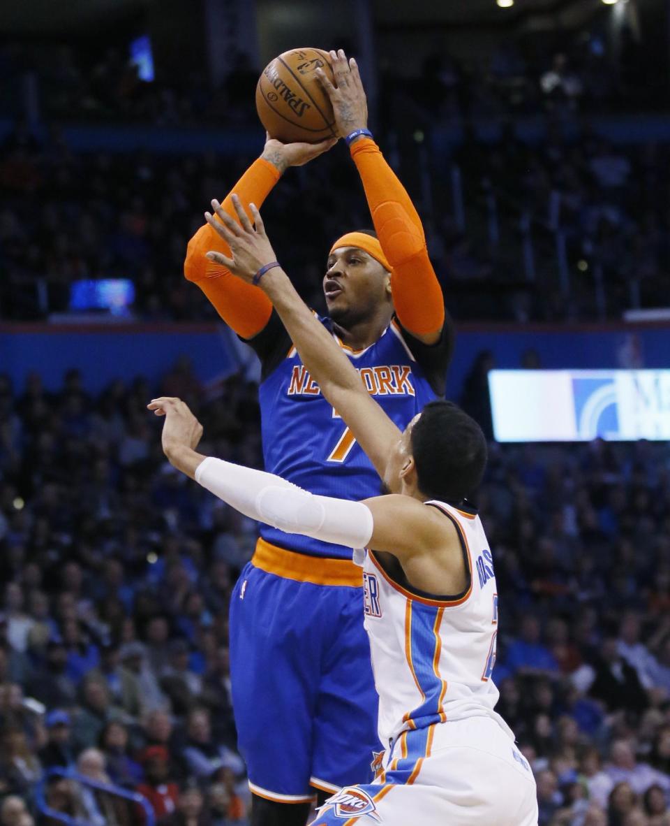 New York Knicks forward Carmelo Anthony (7) shoots over Oklahoma City Thunder forward Andre Roberson during the first quarter of an NBA basketball game in Oklahoma City, Wednesday, Feb. 15, 2017. (AP Photo/Sue Ogrocki)