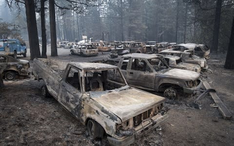 Burned-out vehicles stand in Paradise, California - Credit: David Paul Morris/Bloomberg