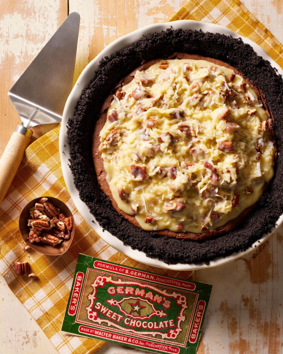 german chocolate pie in a white pie dish with german pecan filling on top