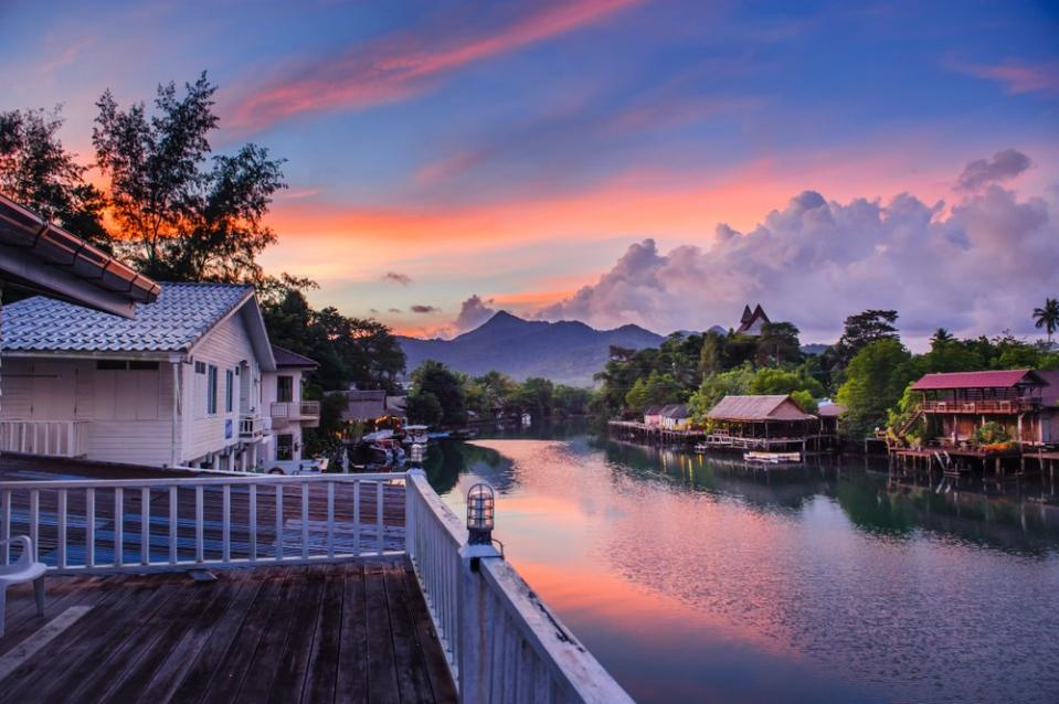 river running through town in Eastern Thailand at dusk