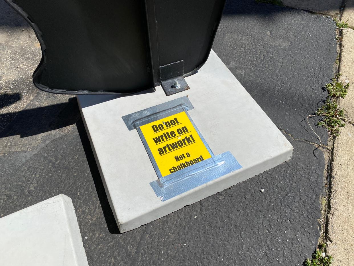 A sign warning people to not write on the "Silverback" sculpture in downtown Tecumseh is pictured Thursday.