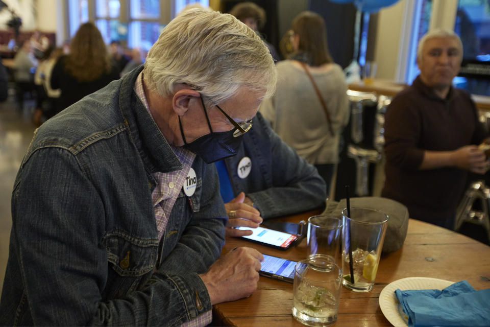 Supporters of democratic gubernatorial candidate Tina Kotek watch the the results of Oregon's primary in Portland, Ore., Tuesday May 17, 2022. (AP Photo/Craig Mitchelldyer)