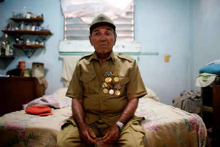 Former rebel Nelson Alvarez, 85, poses for a photo in his home in El Cobre, Cuba, April 2, 2018. REUTERS/Alexandre Meneghini