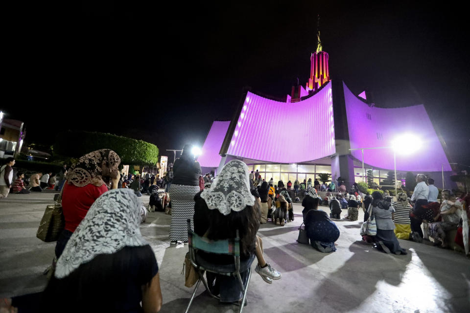 ADDS FIRST NAME - People pray outside the "La Luz Del Mundo" or Light of the World church after they learned their church's leader Naasón Joaquín García was arrested in the U.S., in Guadalajara, Mexico, Tuesday, June 4, 2019. California authorities have charged Garcia, the self-proclaimed apostle of the Mexico-based church that claims over 1 million followers, with child rape, human trafficking and producing child pornography in Southern California. (AP Photo/Refugio Ruiz)
