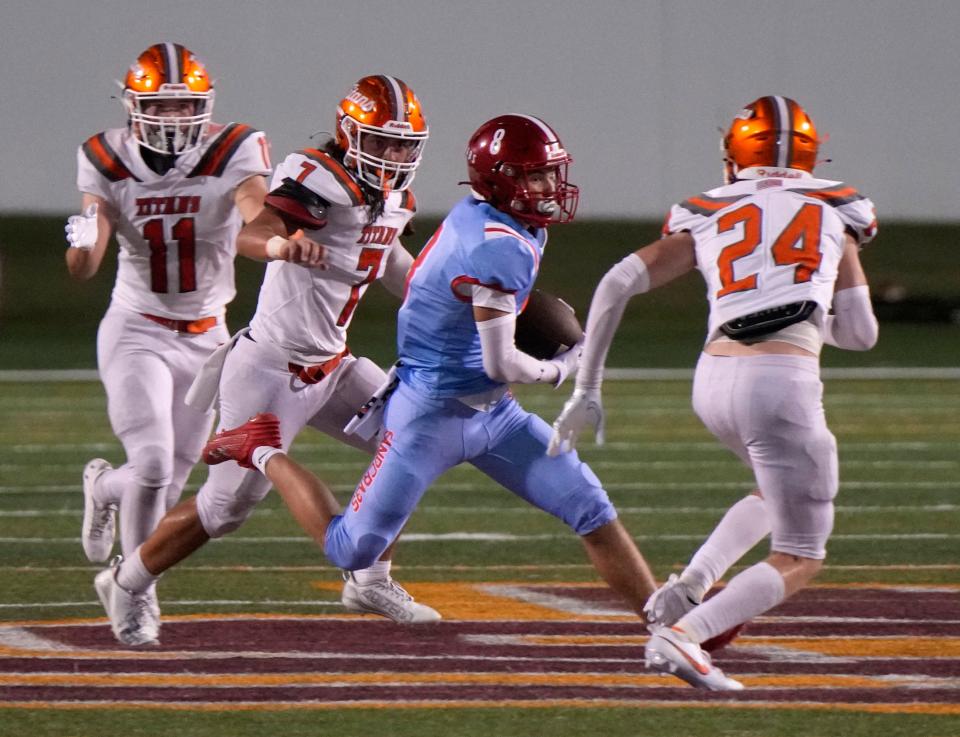 Seabreeze's Landon Smith (8) attempts to run through traffic during a game with University at Daytona Stadium in Daytona Beach, Friday, Sept. 8, 2023. 