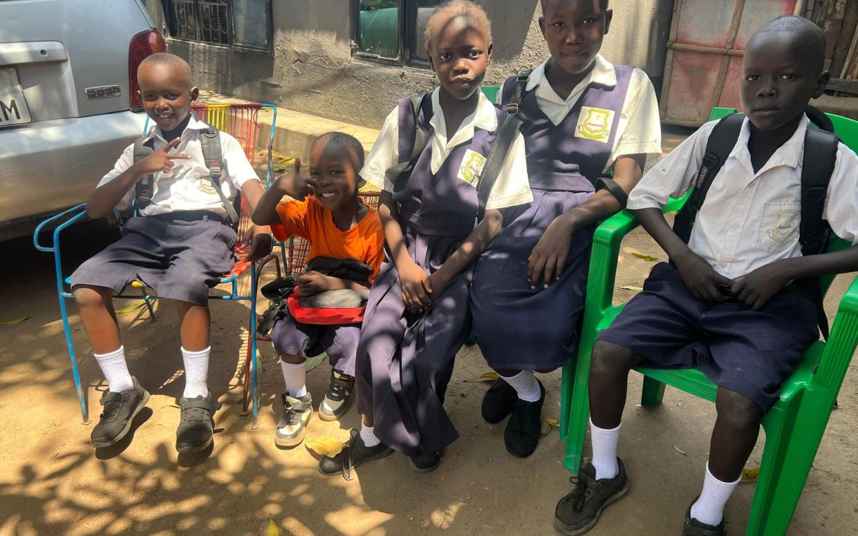 Pupils sit in the shade at a school that is closed by the government due to an extreme heat wave alert for the next days, in Juba, South Sudan