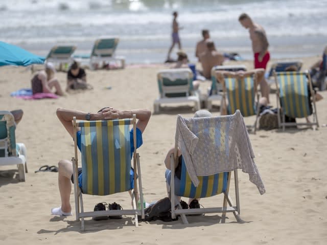 People enjoy the sunshine on the beach in Bournemouth, Dorset