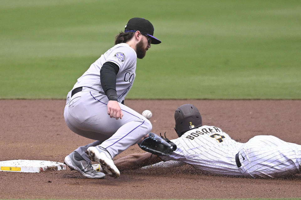 Colorado Rockies second baseman Brendan Rodgers (7) can't handle the throw as San Diego Padres' Xander Bogaerts (2) steals second base during the first inning of a baseball game Wednesday, Sept. 20, 2023, in San Diego. (AP Photo/Denis Poroy)