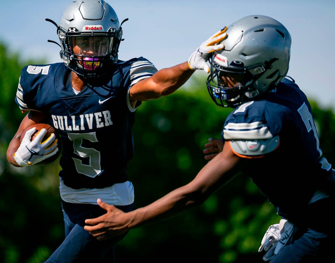 Gulliver Prep wide receiver Jalen Brown stiff arms athlete Darriel Cannon during a preseason practice at their school’s football field in Pinecrest, Florida on Monday, August 9, 2021.