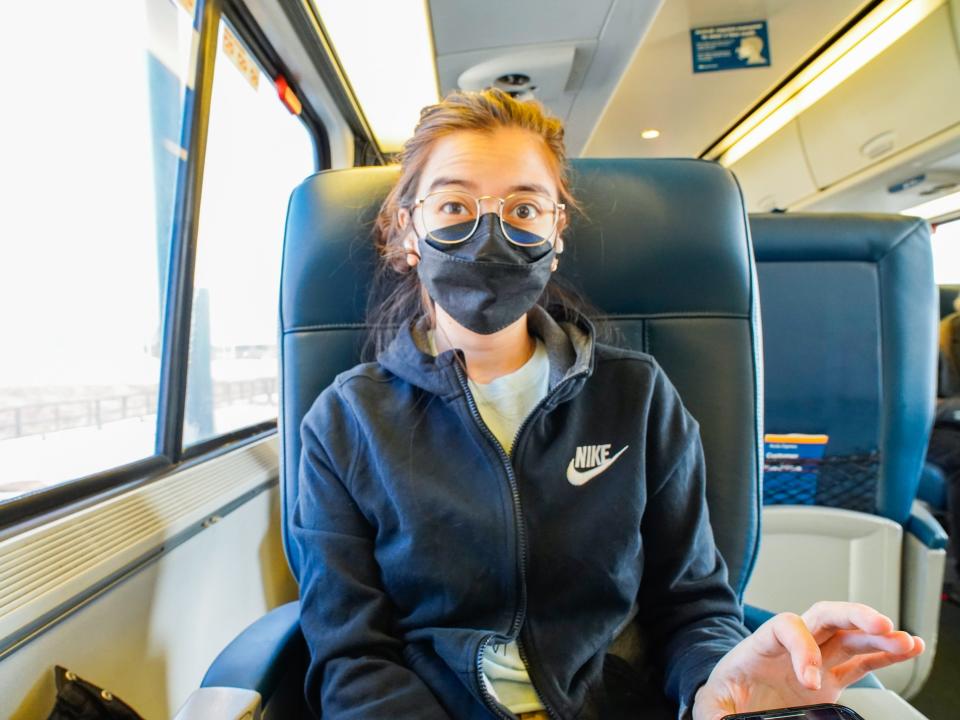 The author sits on an Amtrak train in first class