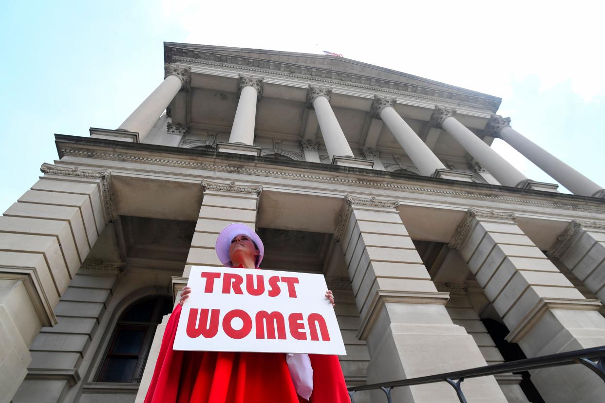 Activist Tamara Stevens with the Handmaids Coalition of Georgia stands outside the Georgia Capitol after Democratic presidential candidate Sen. Kirsten Gillibrand (D-NY) addressed an event to speak out against the recently passed "heartbeat" bill on May 16, 2019 in Atlanta, Georgia. (Photo: JOHN AMIS via Getty Images)