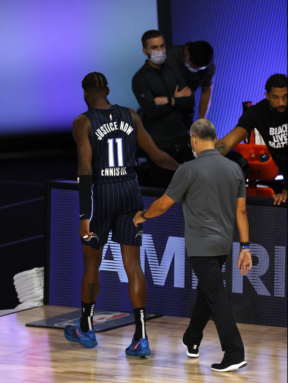 Orlando Magic's James Ennis III leaves the court after being ejected along with Milwaukee Bucks' Marvin Williams during Game 3 of an NBA basketball first-round playoff series, Saturday, Aug. 22, 2020, in Lake Buena Vista, Fla. (Mike Ehrmann/Pool Photo via AP)