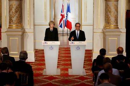 French President Francois Hollande (R) and Britain's Prime Minister Theresa May attend a news conference at the Elysee Palace in Paris, France, July 21, 2016. REUTERS/Philippe Wojazer