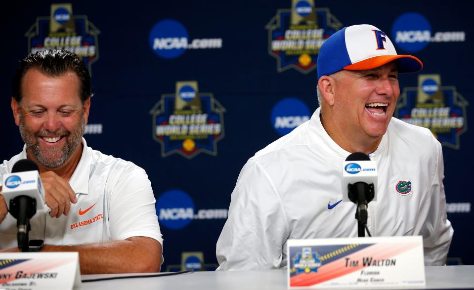 Florida coach Tim Walton and OSU coach Kenny Gajewski laugh during media day at the Women's College World Series in 2019.