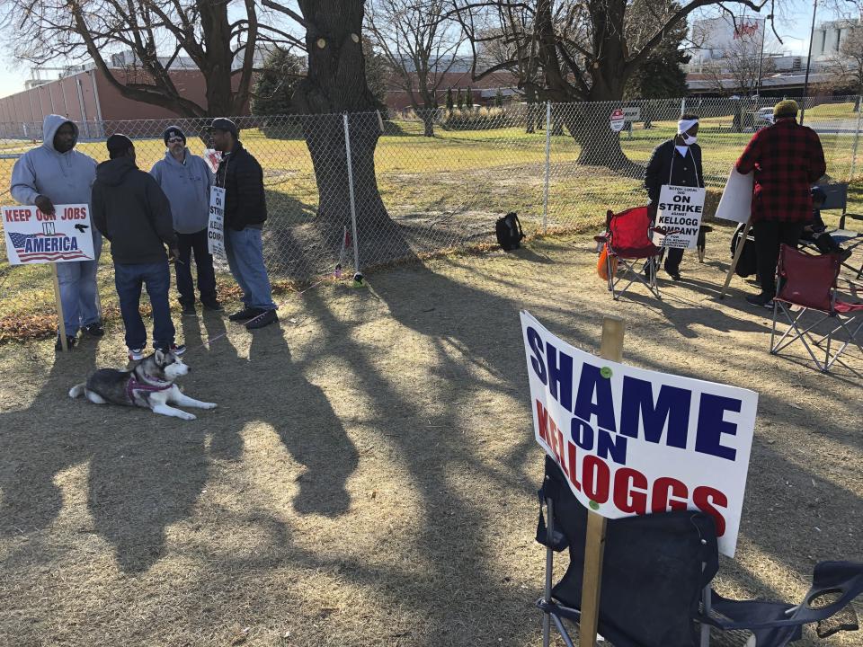 Striking Kellogg's workers stand outside the company's cereal plant in Omaha, Neb., Thursday, Dec. 2, 2021. The company and the union announced a tentative agreement Thursday that could end the strike that began Oct. 5. (AP Photo/ Josh Funk)