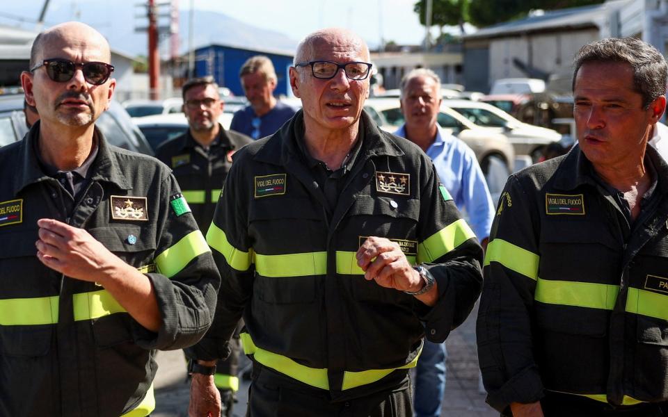 Carlo Dall'Oppio, head of Italy's firefighters, with his crew at the port in Porticello