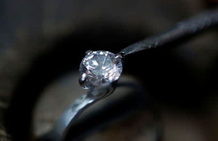 A jeweller repairs a diamond ring in the Clogau workshop in Bodelwyddan, North Wales, Britain, March 12, 2018. REUTERS/Phil Noble