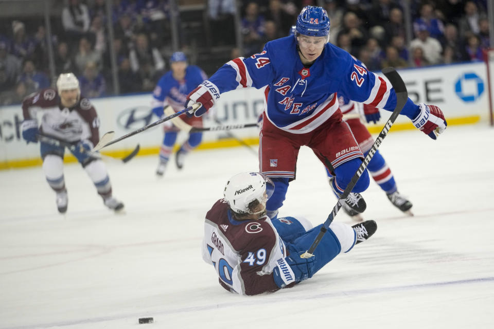 New York Rangers right wing Kaapo Kakko (24) goes over Colorado Avalanche defenseman Samuel Girard (49) during the second period of an NHL hockey game, Monday, Feb. 5, 2024, at Madison Square Garden in New York. (AP Photo/Mary Altaffer)