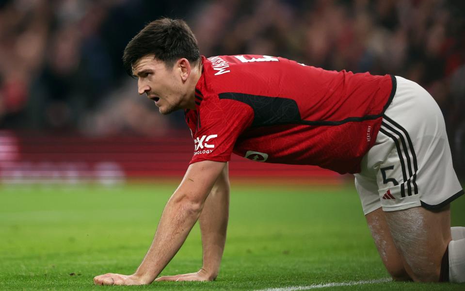 Manchester United's Harry Maguire is grounded during the UEFA Champions League match between Manchester United and FC Bayern Munich at Old Trafford on December 12, 2023 in Manchester, England