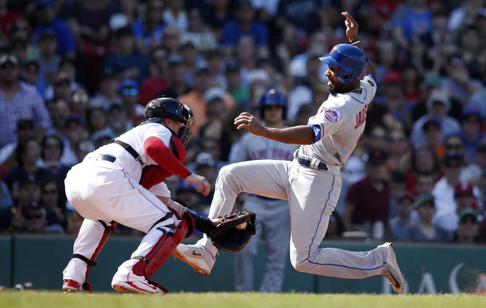 New York Mets' Austin Jackson, right, scores against Boston Red Sox's Christian Vazquez on a sacrifice fly by Wilmer Flores during the sixth inning of a baseball game in Boston, Sunday, Sept. 16, 2018. (AP Photo/Michael Dwyer)