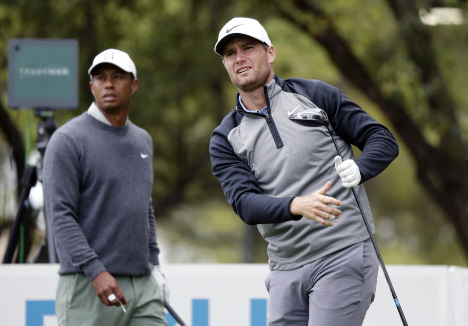 Lucas Bjerregaard, right, watches his drive on the eighth hole as Tiger Woods, left, looks on during quarterfinal play at the Dell Technologies Match Play Championship golf tournament, Saturday, March 30, 2019, in Austin, Texas. Bjerregaard won the match. (AP Photo/Eric Gay)