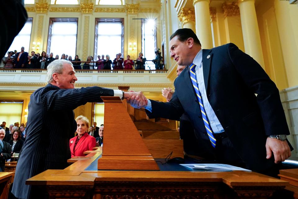 Gov. Phil Murphy, left, shakes hands with Senate President Nick Scutari before Murphy's budget address at the New Jersey Statehouse on Tuesday, Feb. 28, 2023.