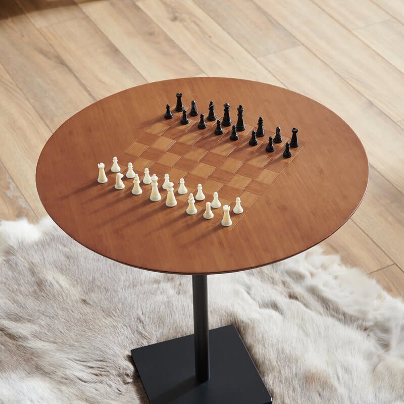 This pedestal chess table features a board in the middle &mdash; the squares have a bamboo-like texture to make them look much more realistic. It has a metal base so you won't have to worry about too much shaking during an intense game. <a href="https://fave.co/3lD44nu" target="_blank" rel="noopener noreferrer">Find it for $80 at Wayfair</a>. 