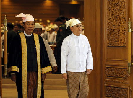 Shwe Man (L), Speaker of the Union Parliament, and Myanmar's President Thein Sein exit after he gave a speech at the regular 9th section of the Union parliament on the final day in Nyapyitaw in this March 26, 2014 file photo. REUTERS/Soe Zeya Tun