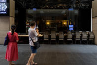 A man snaps a picture of a closed restaurant inside the Pavilion shopping mall on 18 March 2020, the first day of the Movement Control Order. (PHOTO: Fadza Ishak for Yahoo Malaysia)