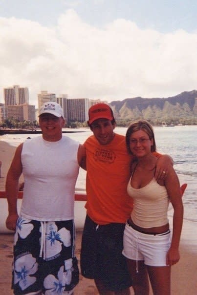 A fan and her husband posing with Adam Sandler in Hawaii