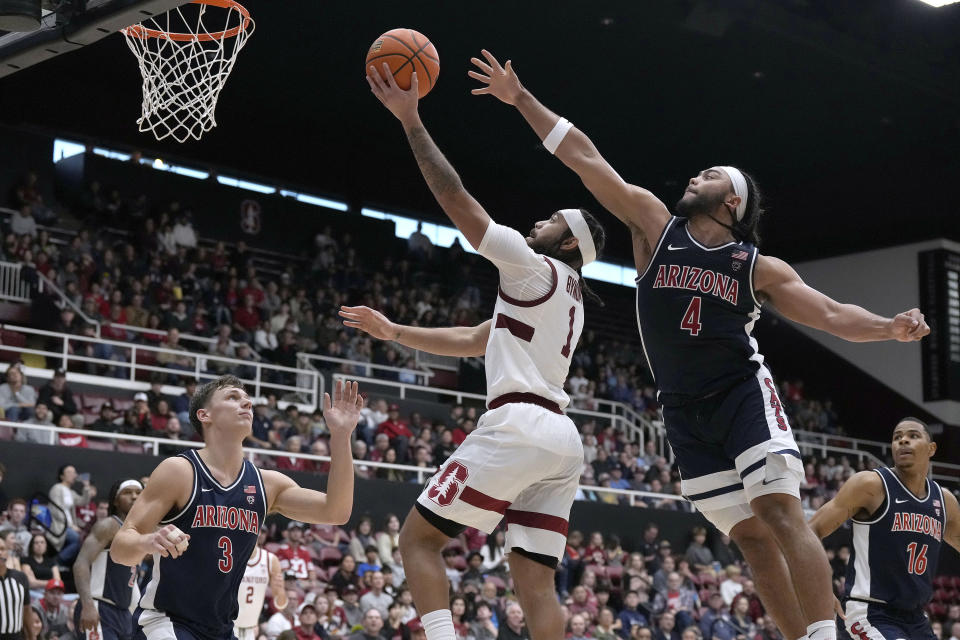 Stanford guard Jared Bynum (1) drives to the basket against Arizona's Kylan Boswell (4) and Pelle Larsson (3) during the second half of an NCAA college basketball game, Sunday, Dec. 31, 2023, in Stanford, Calif. (AP Photo/Tony Avelar)